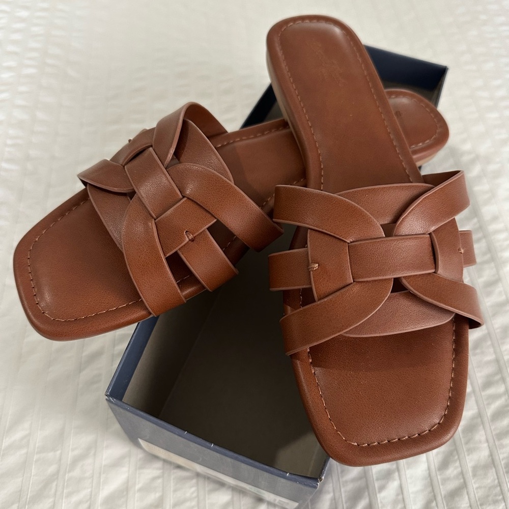 Slip on/slide sandal in a brown/cognac color.